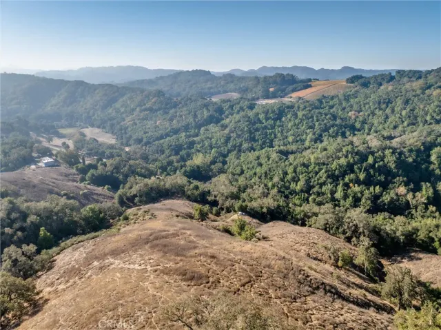 a view of a mountain range with trees in the background