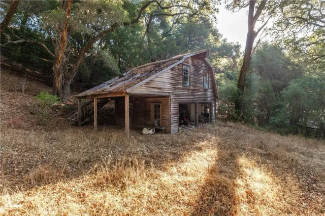 a view of a house with yard and sitting area