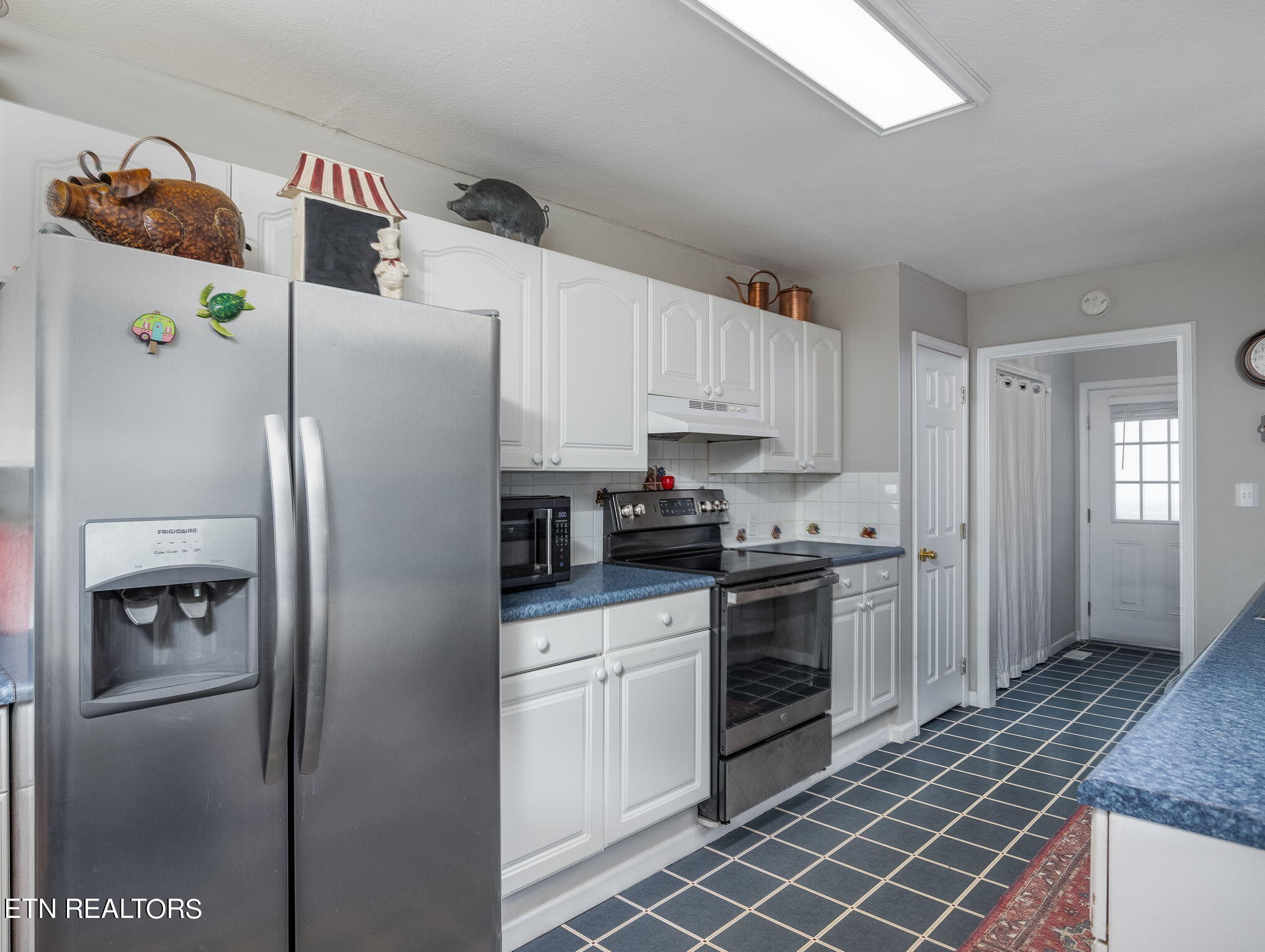 5316 Shipe Road Corryton, TN 37721 - Photo 18 of 36 a kitchen with stainless steel appliances a refrigerator sink and microwave