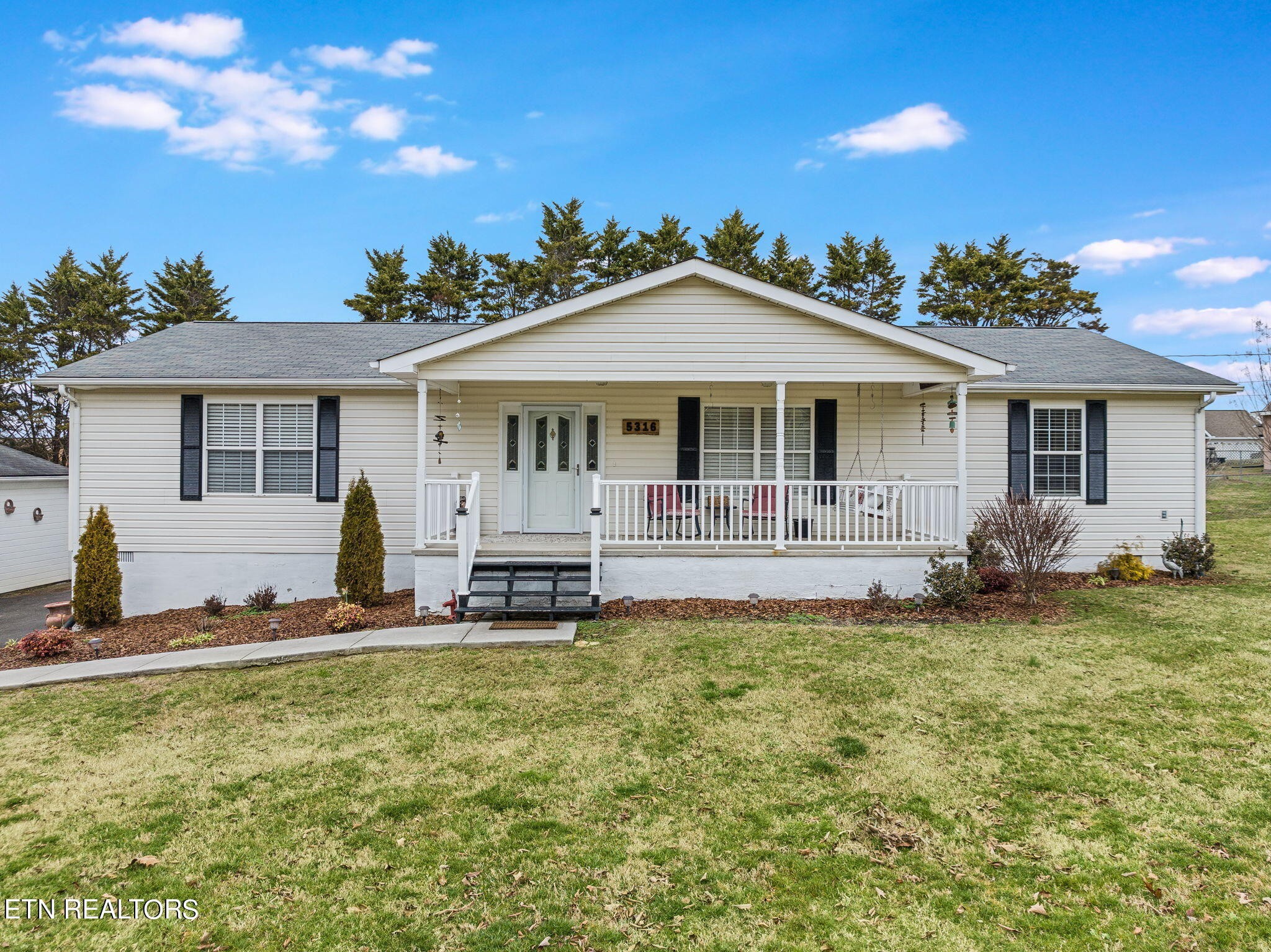 5316 Shipe Road Corryton, TN 37721 - Photo 3 of 36 a front view of a house with a yard table and chairs