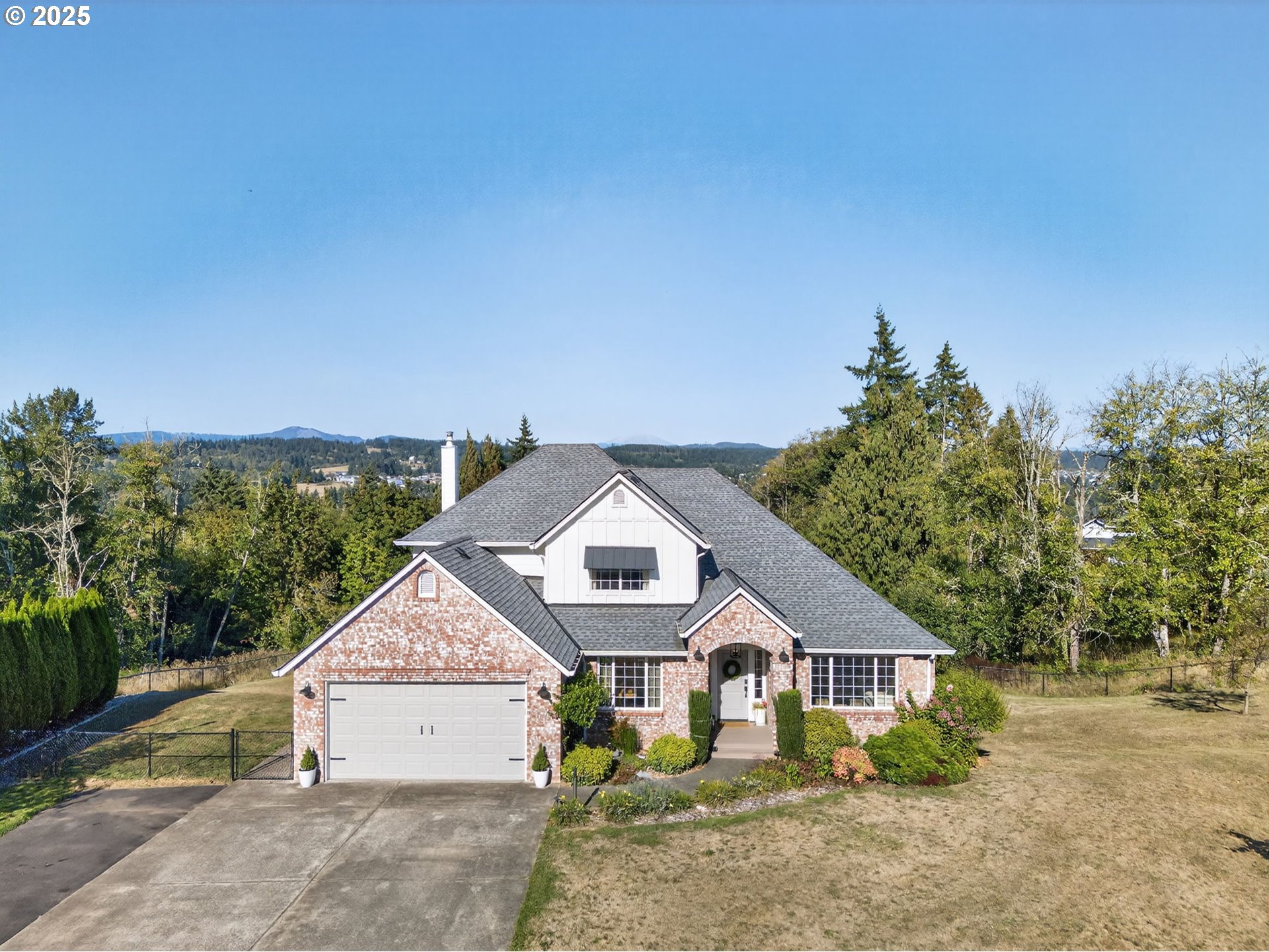 32102 Northwest Eagle Crest Drive Ridgefield, WA 98642 - Photo 2 of 48 an aerial view of a house with a big yard and large trees