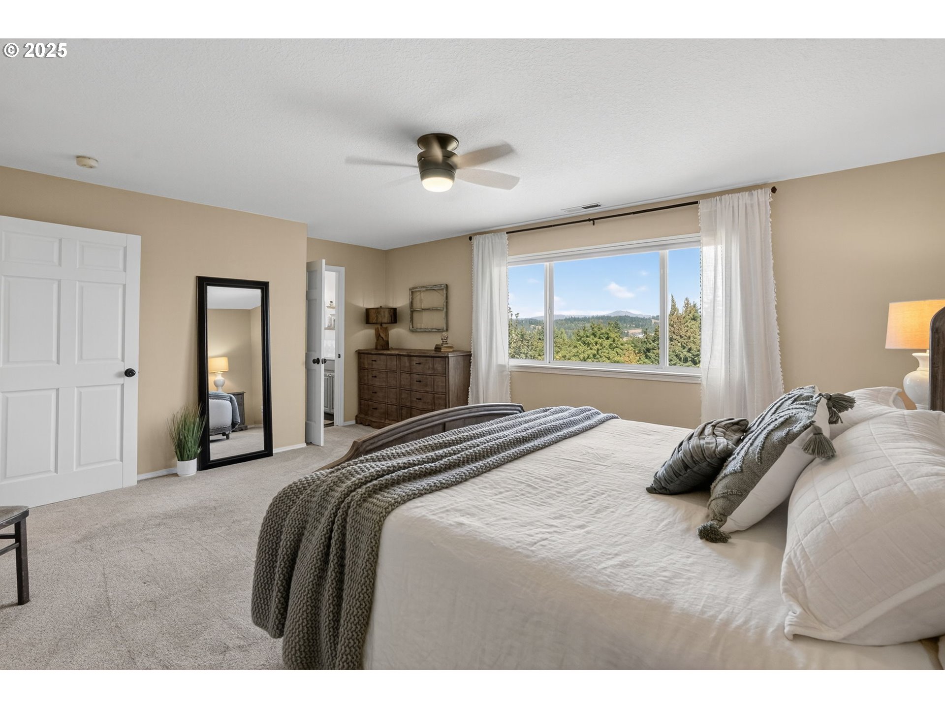 32102 Northwest Eagle Crest Drive Ridgefield, WA 98642 - Photo 22 of 48 a bedroom with a bed and glass windows