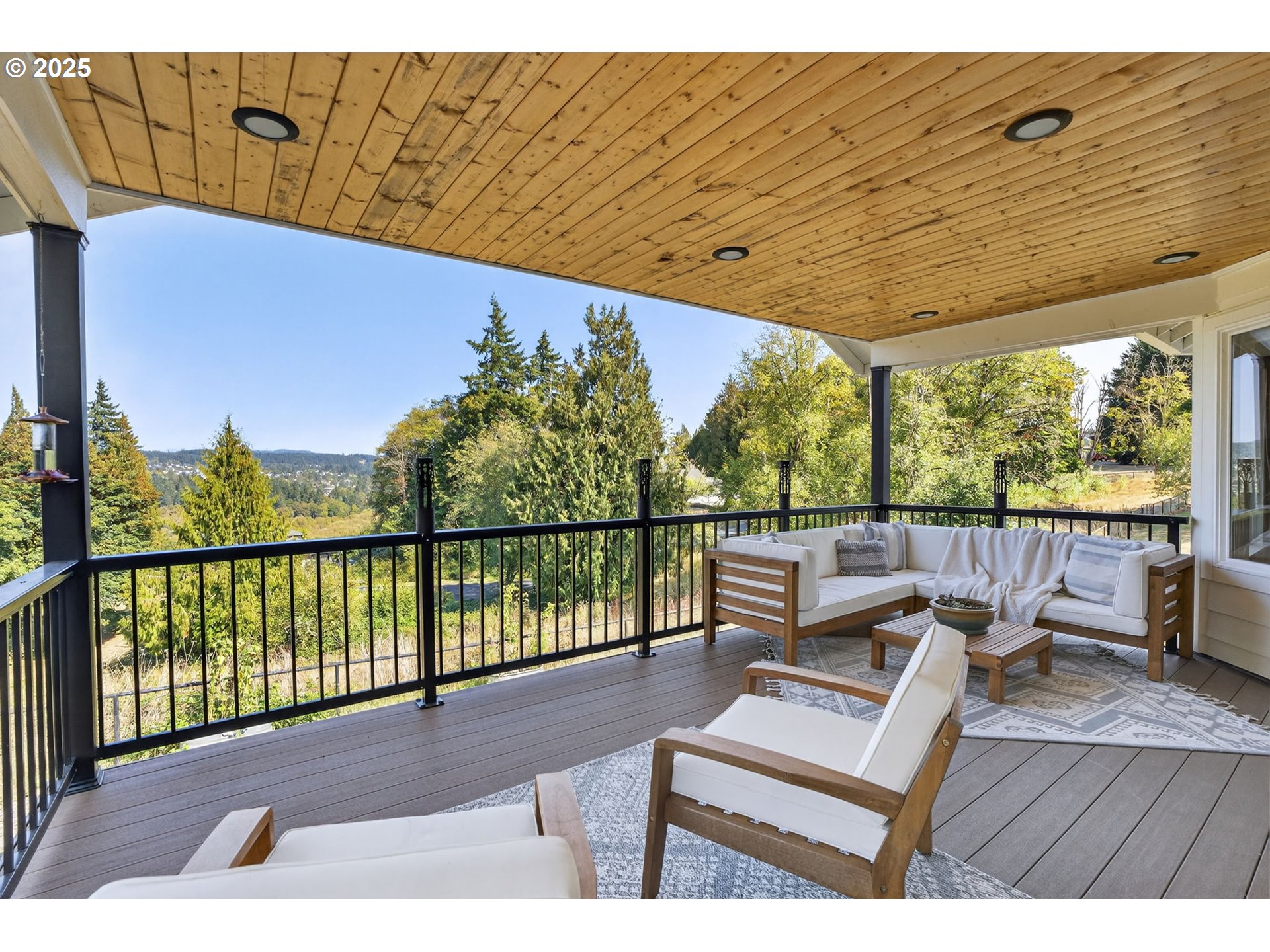 32102 Northwest Eagle Crest Drive Ridgefield, WA 98642 - Photo 30 of 48 a view of a balcony with wooden floor and outdoor seating