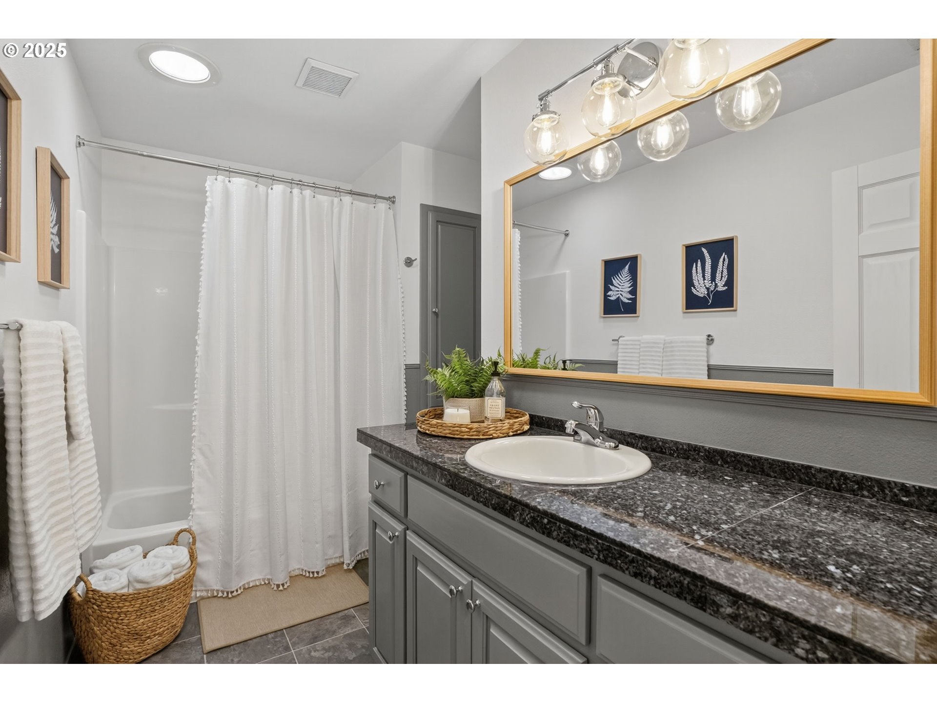 32102 Northwest Eagle Crest Drive Ridgefield, WA 98642 - Photo 31 of 48 a bathroom with a granite countertop sink a mirror and a shower