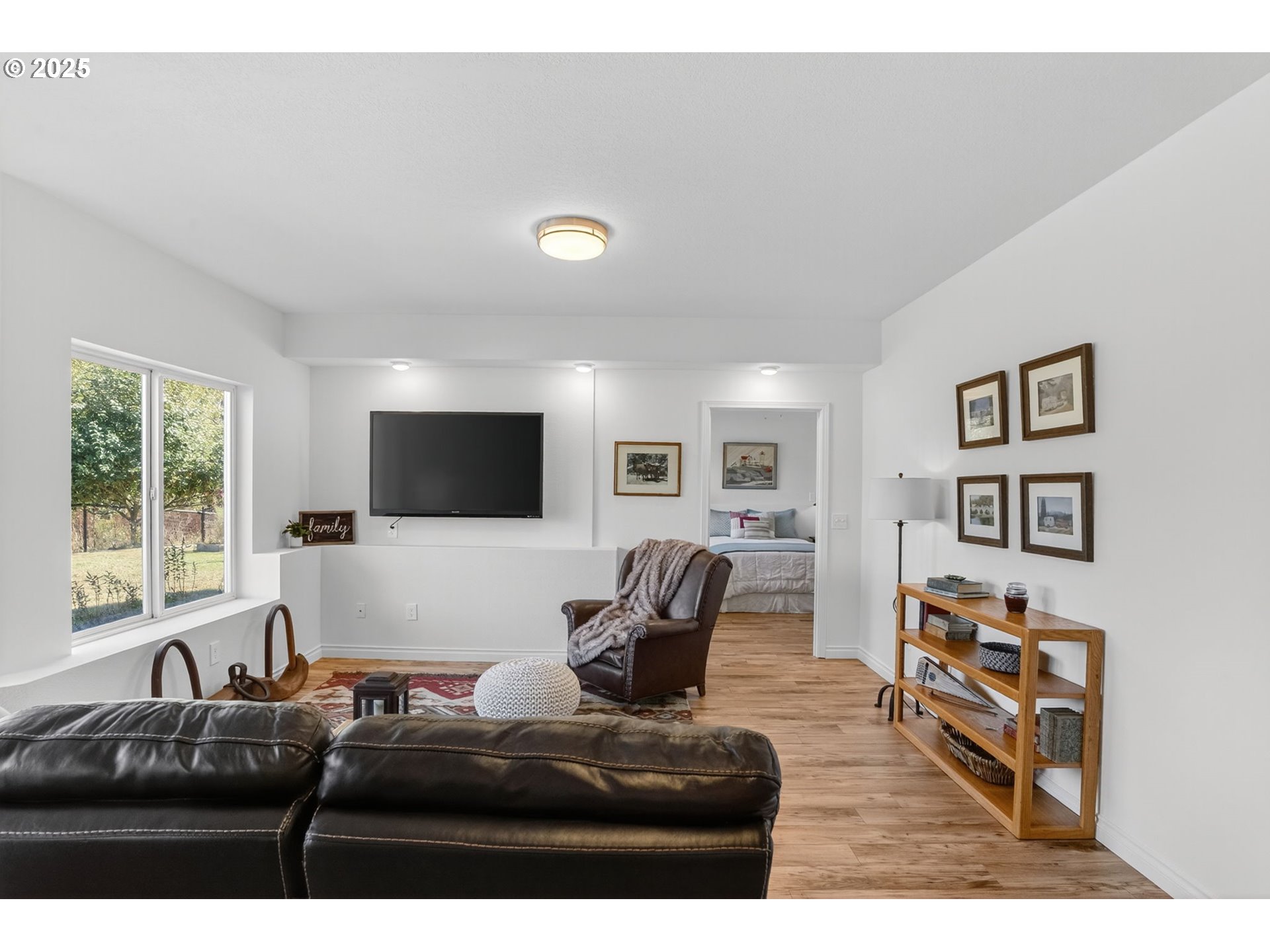 32102 Northwest Eagle Crest Drive Ridgefield, WA 98642 - Photo 33 of 48 a living room with furniture and a flat screen tv
