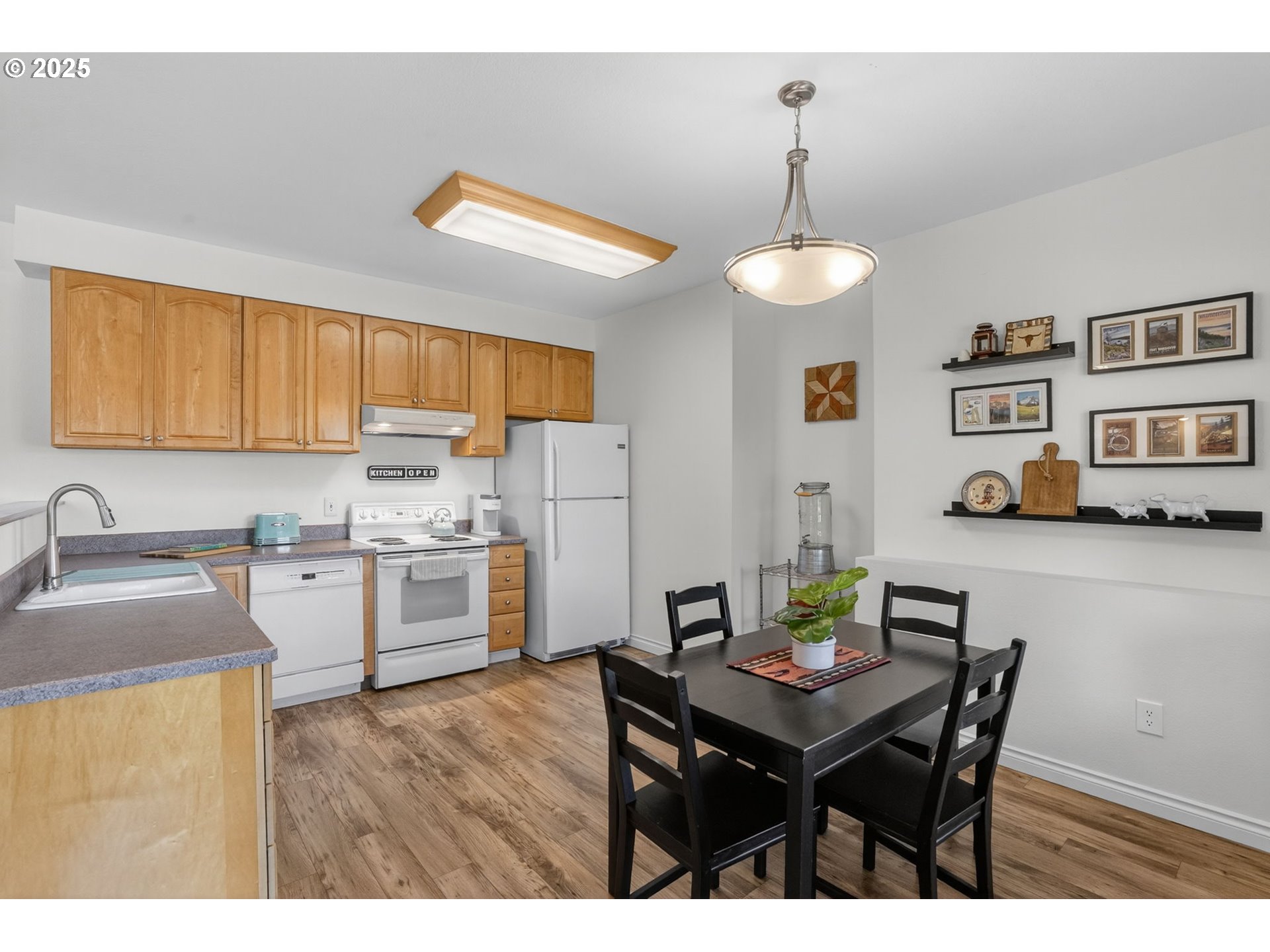 32102 Northwest Eagle Crest Drive Ridgefield, WA 98642 - Photo 38 of 48 a kitchen with a refrigerator a stove a sink dishwasher with a dining table and chairs