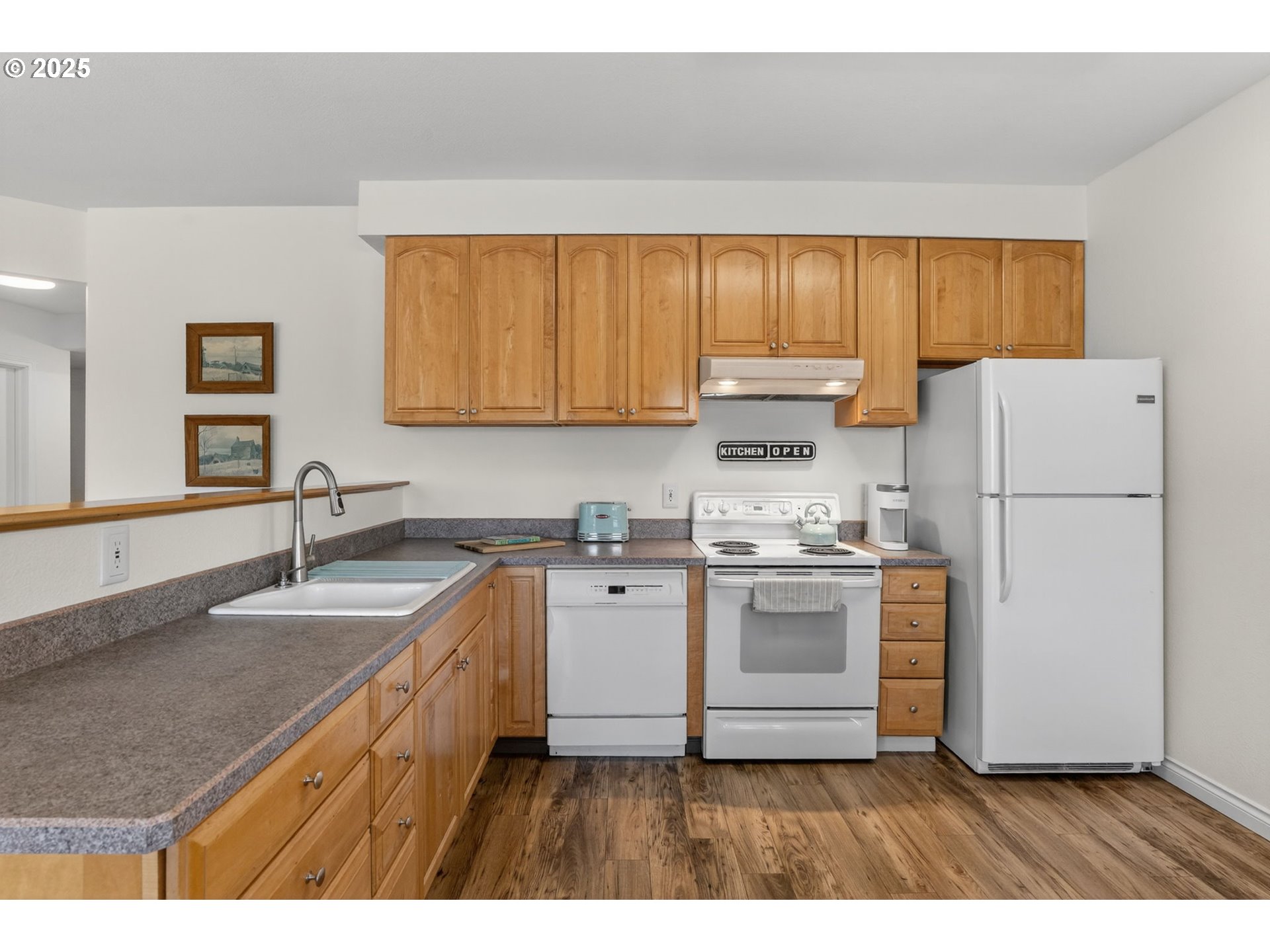 32102 Northwest Eagle Crest Drive Ridgefield, WA 98642 - Photo 39 of 48 a kitchen with a sink a stove a refrigerator and a microwave