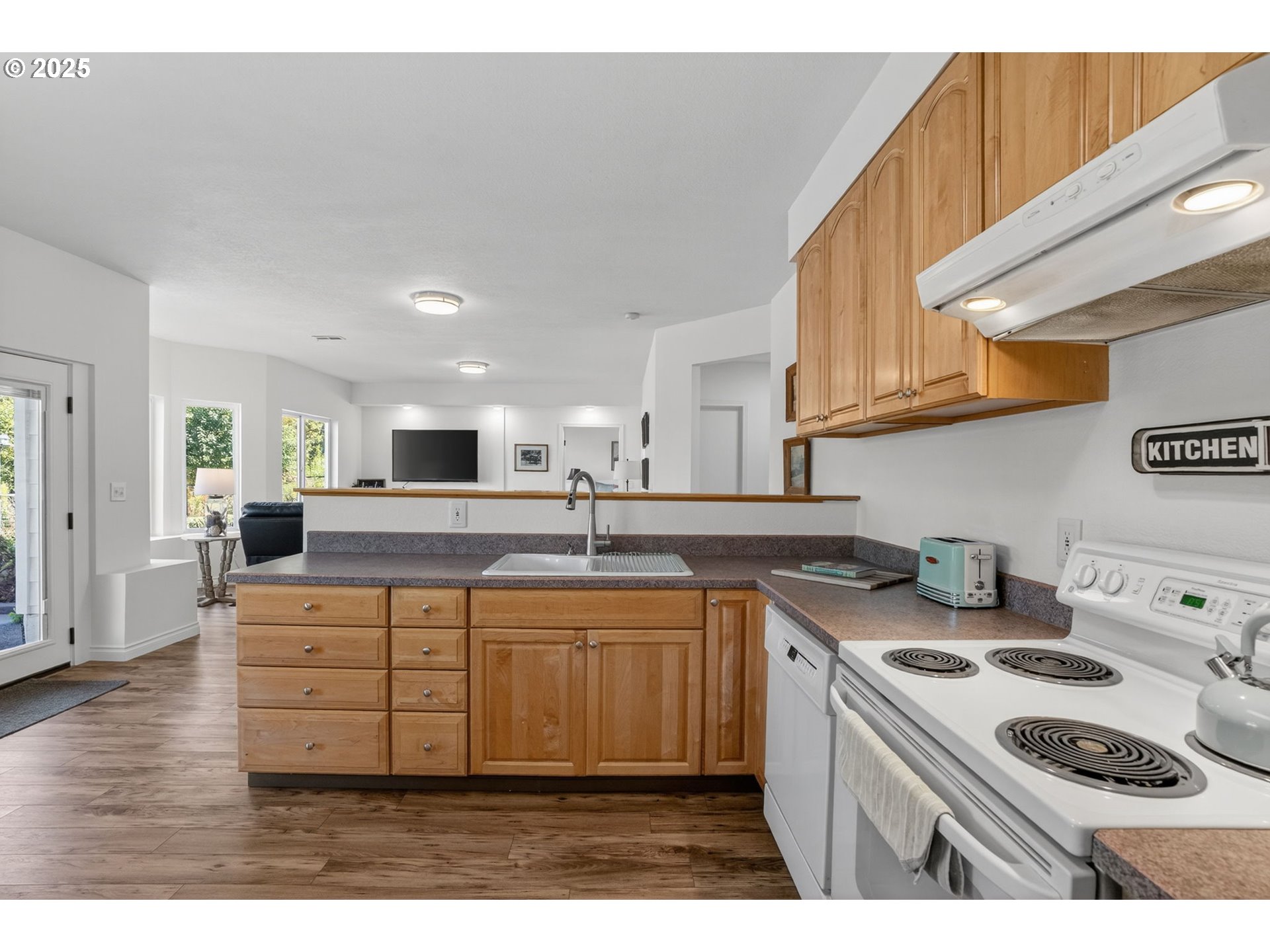 32102 Northwest Eagle Crest Drive Ridgefield, WA 98642 - Photo 40 of 48 a kitchen with kitchen island a sink stove top oven and cabinets