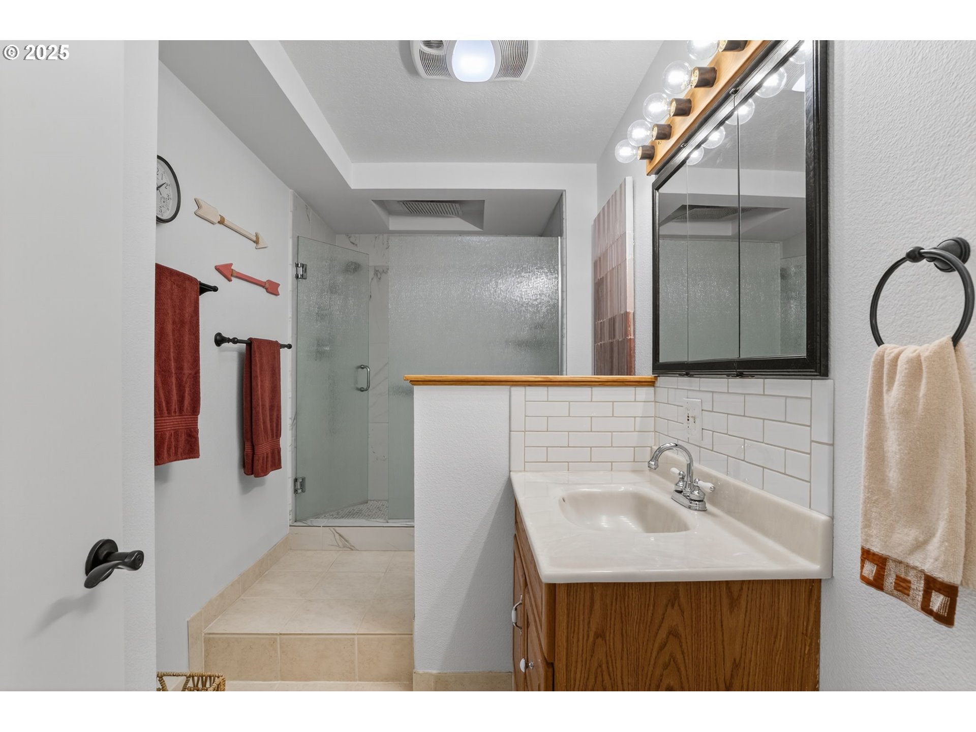 32102 Northwest Eagle Crest Drive Ridgefield, WA 98642 - Photo 41 of 48 a bathroom with a sink a mirror and shower