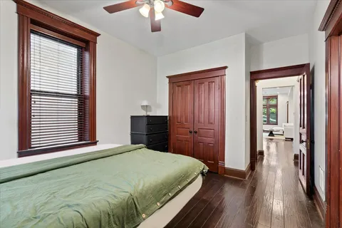 a bedroom with a bed and a chandelier