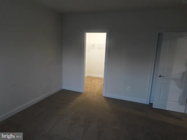 a bathroom with a granite countertop toilet and a sink