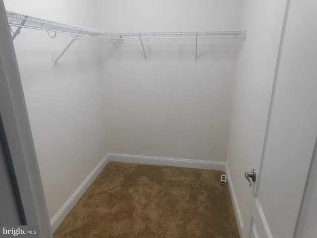 a bathroom with a granite countertop toilet and a sink