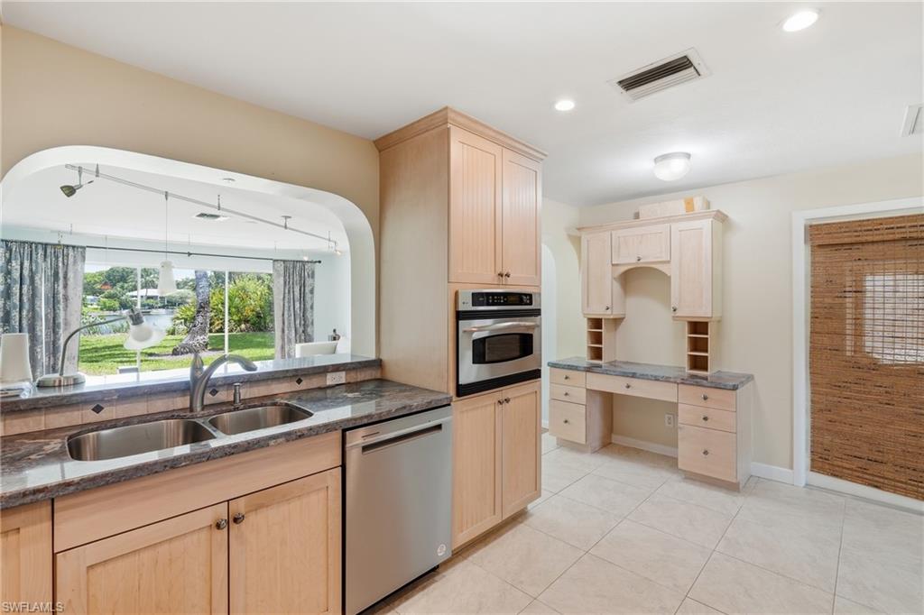 1316 Rordon Avenue Naples, FL 34103 - Photo 12 of 38 Kitchen featuring a double basin stainless steel sink, granite countertops, and light wood cabinetry