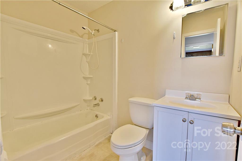 243 Eden Circle Pineville, NC 28134 - Photo 13 of 18 a bathroom with a sink a toilet and shower