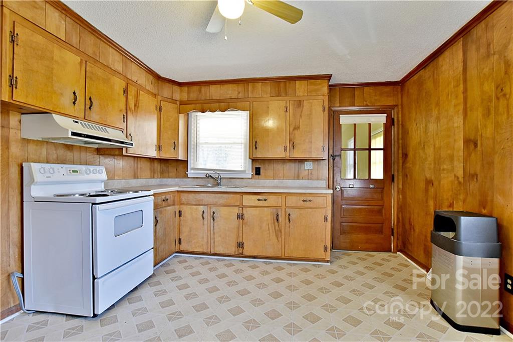 243 Eden Circle Pineville, NC 28134 - Photo 7 of 18 a kitchen with a stove a sink and a refrigerator