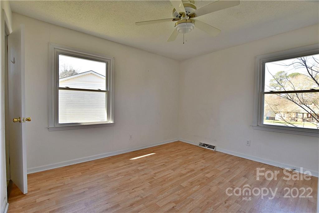 243 Eden Circle Pineville, NC 28134 - Photo 9 of 18 a view of an empty room with wooden floor and window
