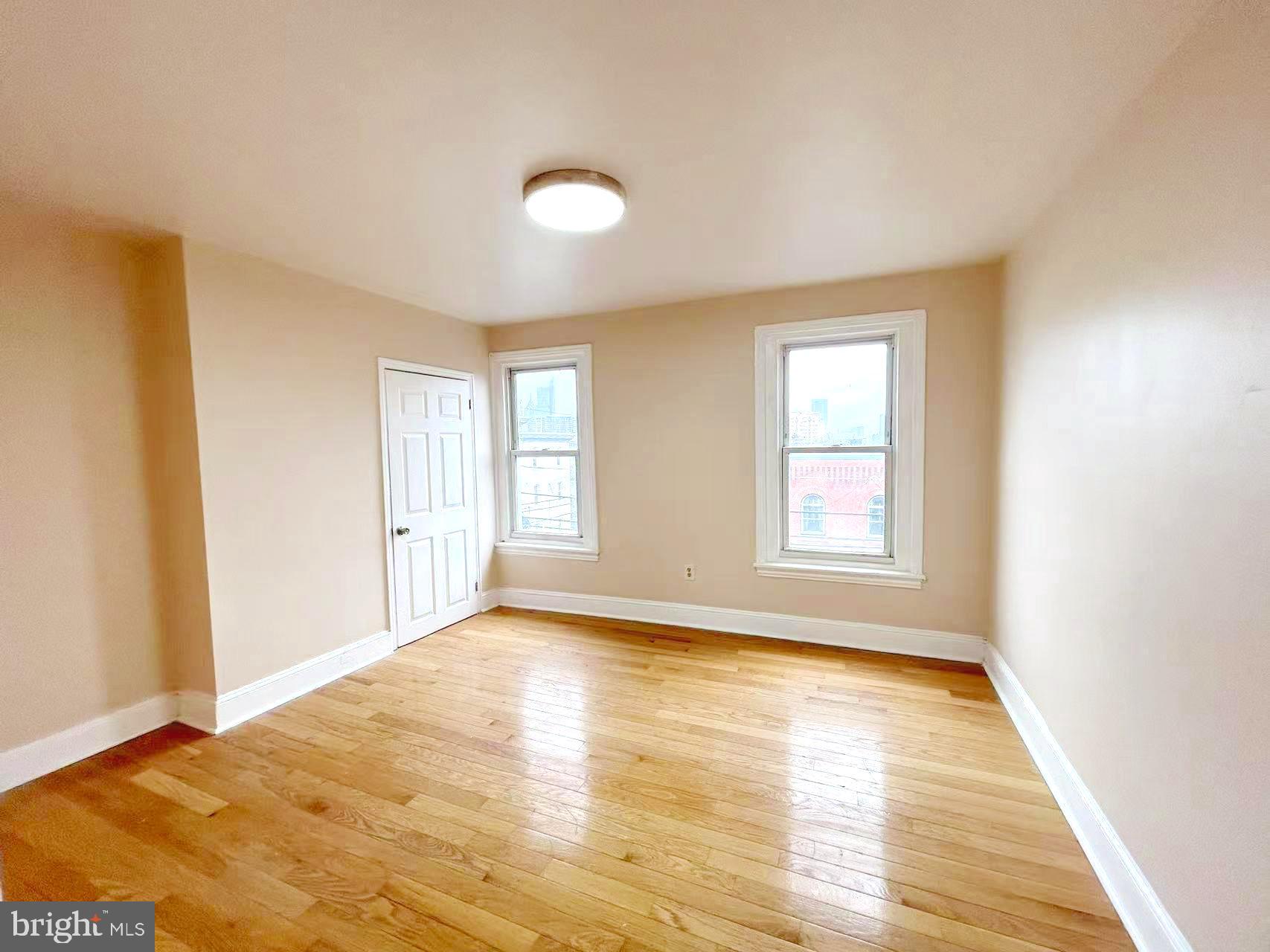 2703 Poplar Street Philadelphia, PA 19130 - Photo 20 of 21 a view of empty room with wooden floor and fan
