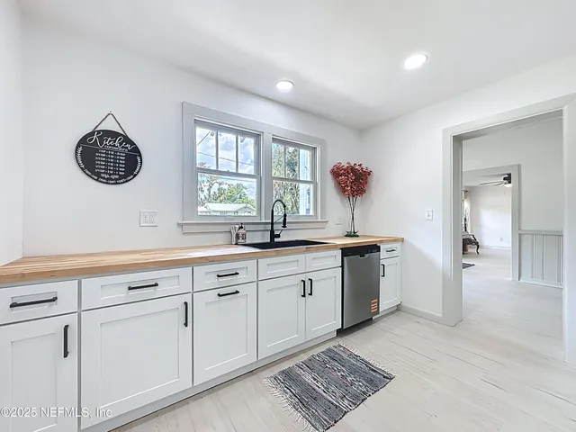 a spacious bathroom with a sink and a window
