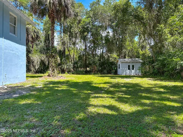 a swimming pool with outdoor seating and yard