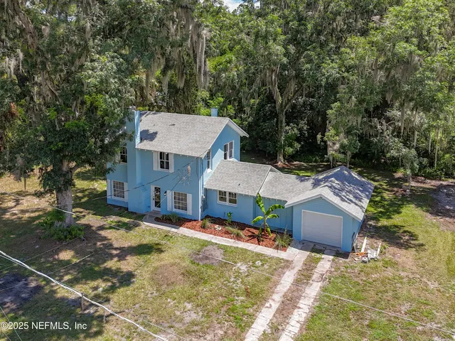 a house view with swimming pool in front of it