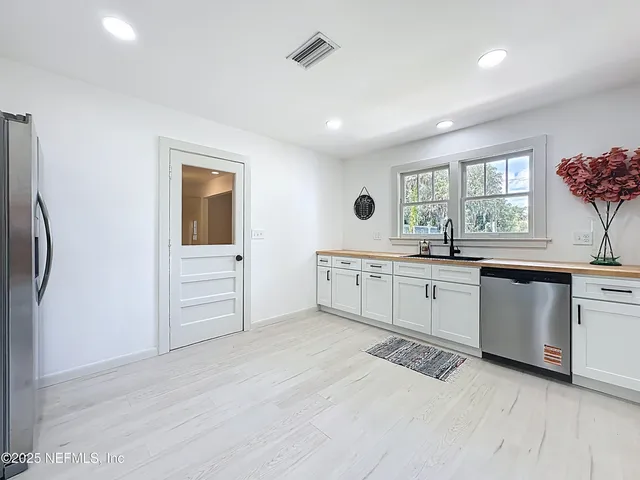 a kitchen with a sink cabinets and window