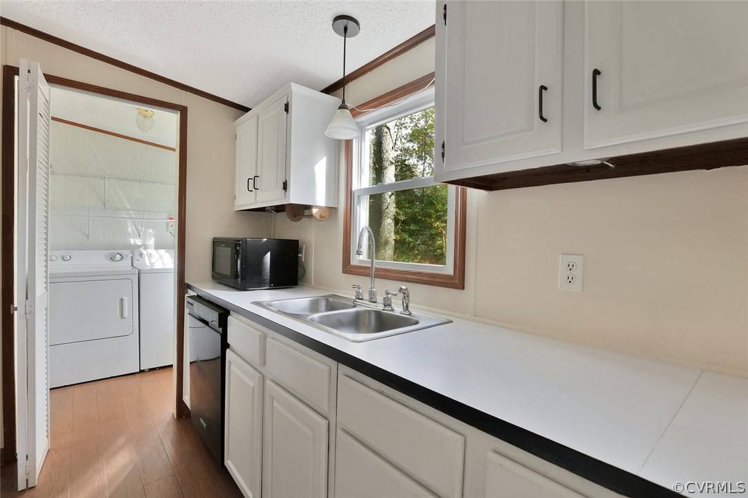 13131 Bradley Bridge Road Chester, VA 23831 - Photo 8 of 21 a kitchen with stainless steel appliances a sink dishwasher a refrigerator and white cabinets with wooden floor