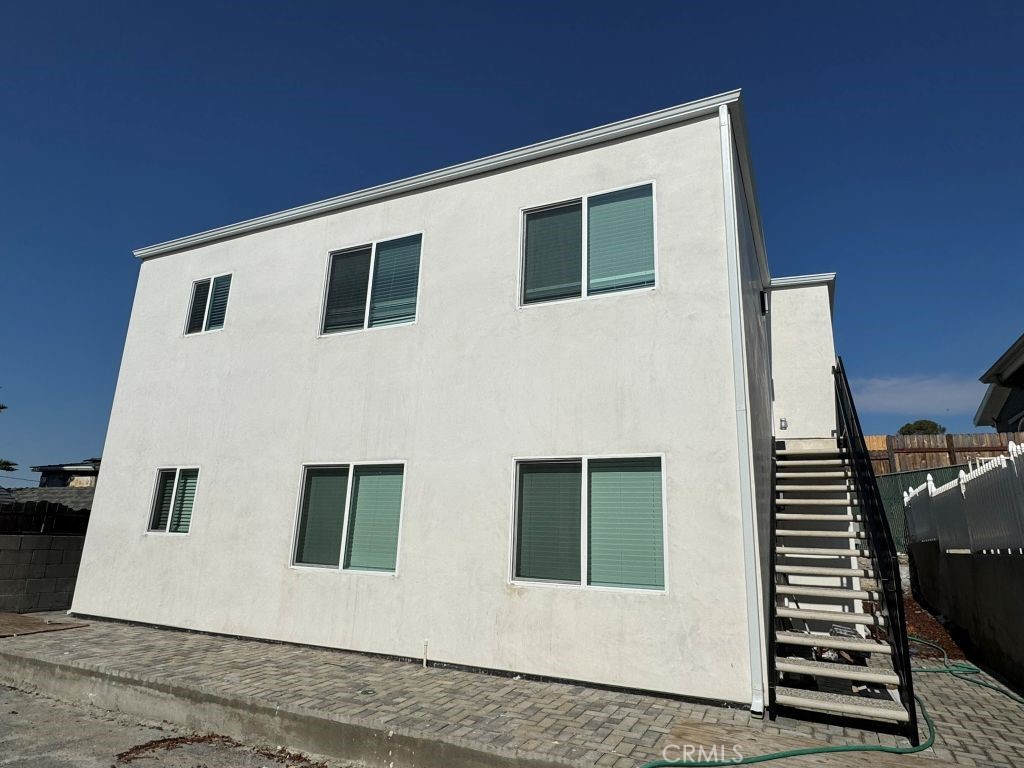 7149 Apperson Street, Unit 2 Tujunga, CA 91042 - Photo 12 of 12 a view of a house with barbeque grill and wooden wall