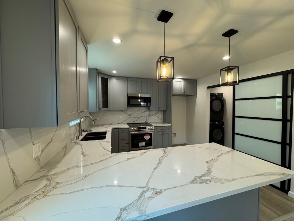 7149 Apperson Street, Unit 2 Tujunga, CA 91042 - Photo 2 of 12 a kitchen with stainless steel appliances kitchen island granite countertop a sink a refrigerator and chairs