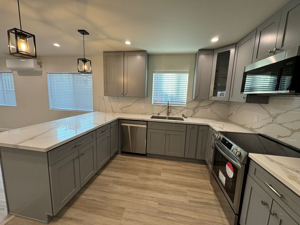 7149 Apperson Street, Unit 2 Tujunga, CA 91042 - Photo 4 of 12 a kitchen with stainless steel appliances granite countertop a sink a stove top oven a counter space and cabinets
