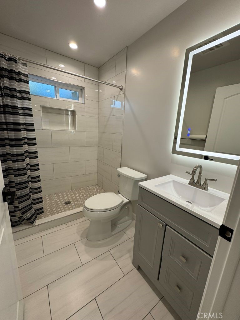 7149 Apperson Street, Unit 2 Tujunga, CA 91042 - Photo 10 of 12 a bathroom with a sink a toilet and shower