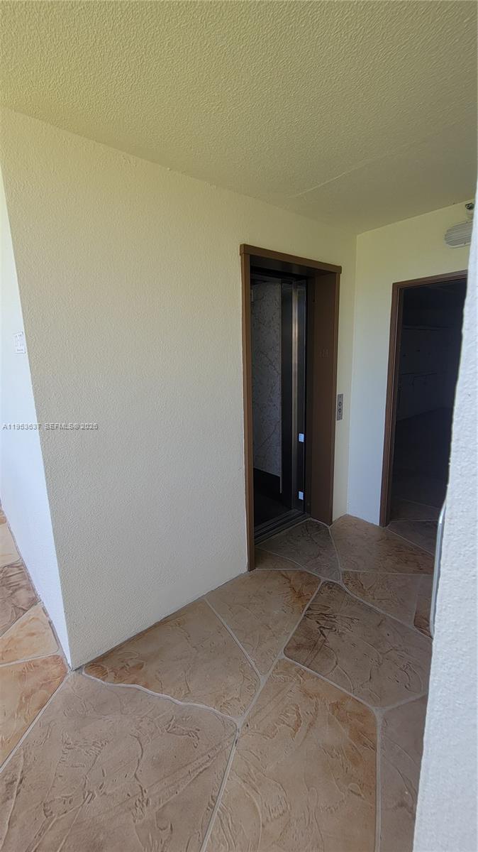 272 Mansfield H, Unit 272 Boca Raton, FL 33434 - Photo 11 of 17 a view of an empty room and closet area