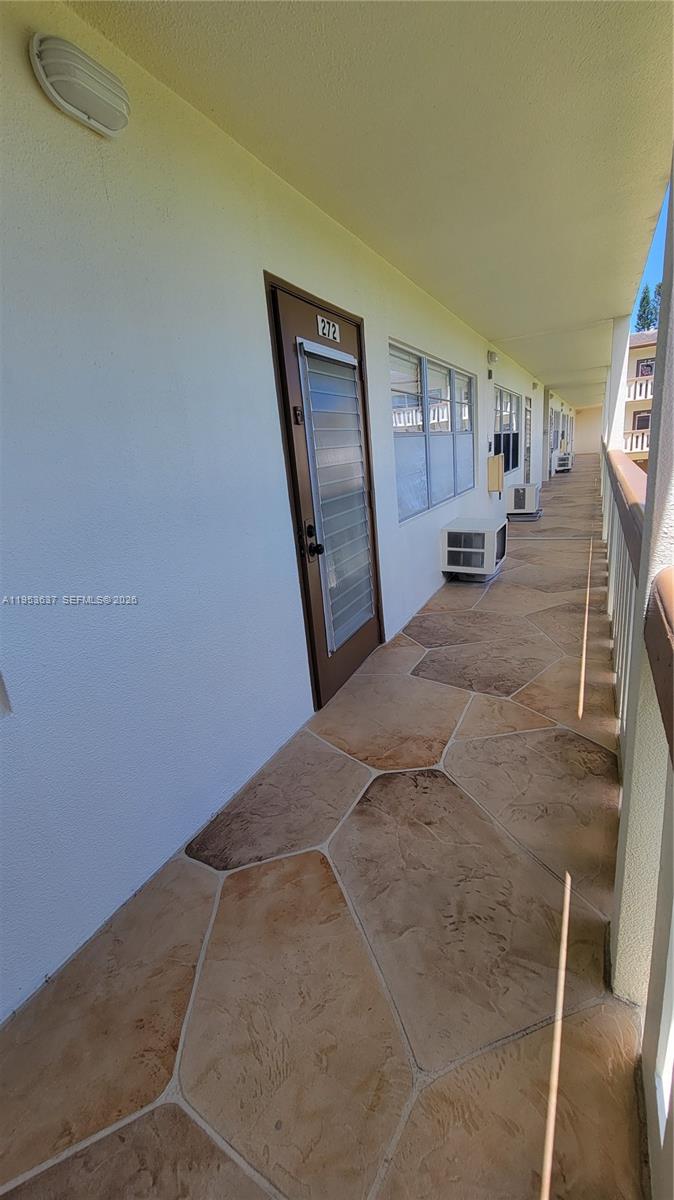 272 Mansfield H, Unit 272 Boca Raton, FL 33434 - Photo 12 of 17 a view of a livingroom with wooden furniture