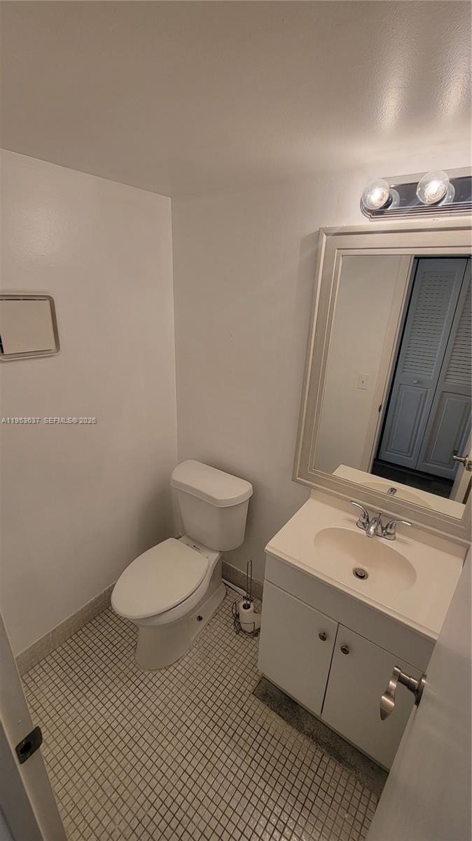 272 Mansfield H, Unit 272 Boca Raton, FL 33434 - Photo 5 of 17 a bathroom with a sink toilet and vanity