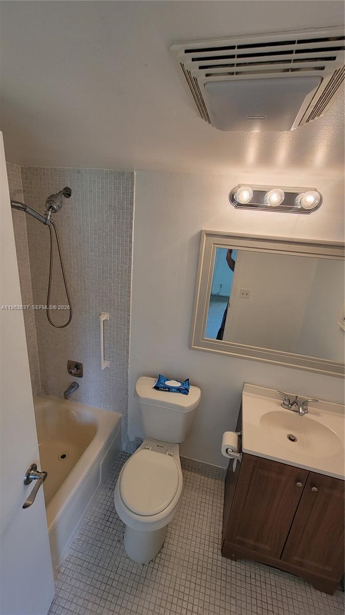 272 Mansfield H, Unit 272 Boca Raton, FL 33434 - Photo 6 of 17 a bathroom with a sink a toilet and shower