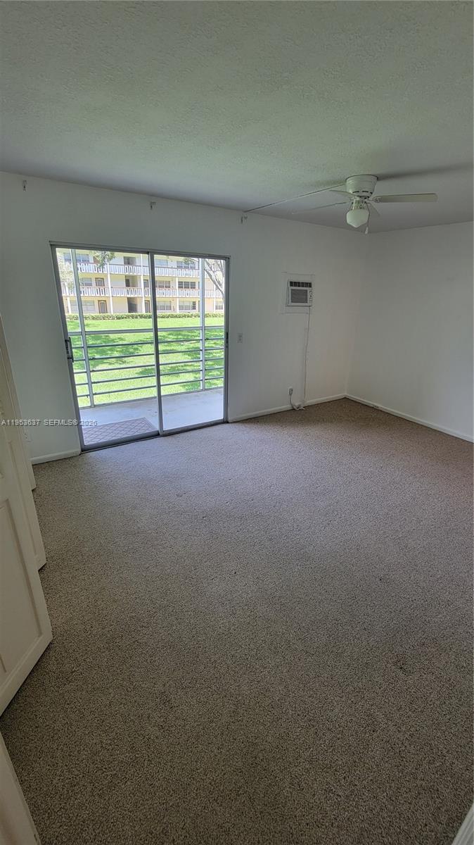 272 Mansfield H, Unit 272 Boca Raton, FL 33434 - Photo 10 of 17 a view of an empty room with a window