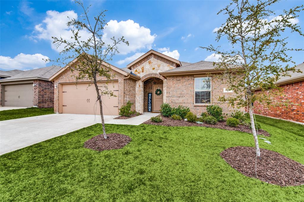 928 Roland Drive Fate, TX 75189 - Photo 1 of 1 a front view of a house with a garden and plants