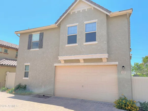 a view of a house with a yard and sitting area