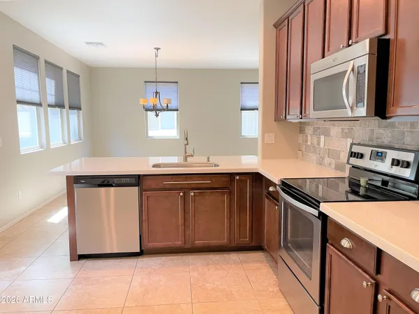 a kitchen with stainless steel appliances granite countertop a sink and a stove