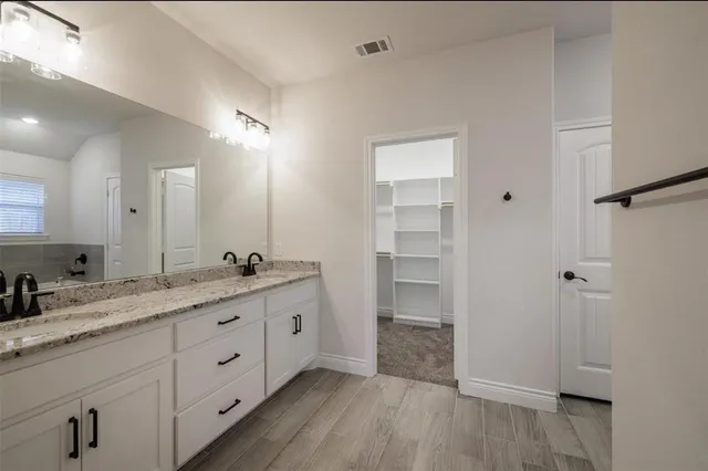 a bathroom with a granite countertop sink mirror and