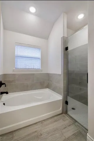 a bathroom with a bathtub and a shower