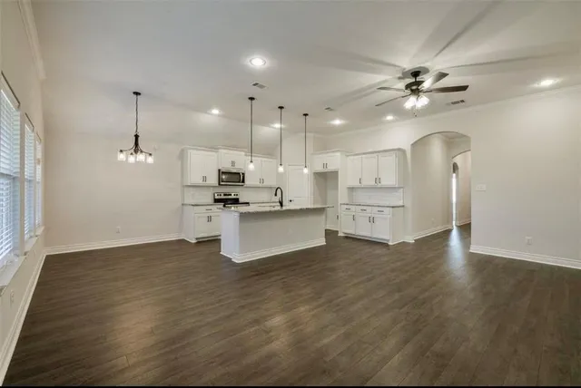 a view of kitchen with cabinets appliances and wooden floor