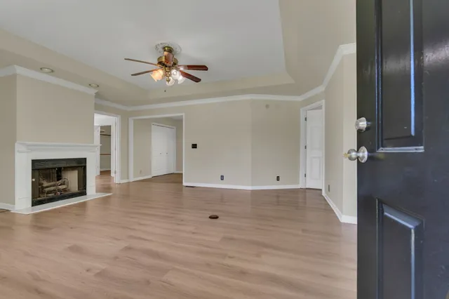 a view of an empty room with a fireplace and a window
