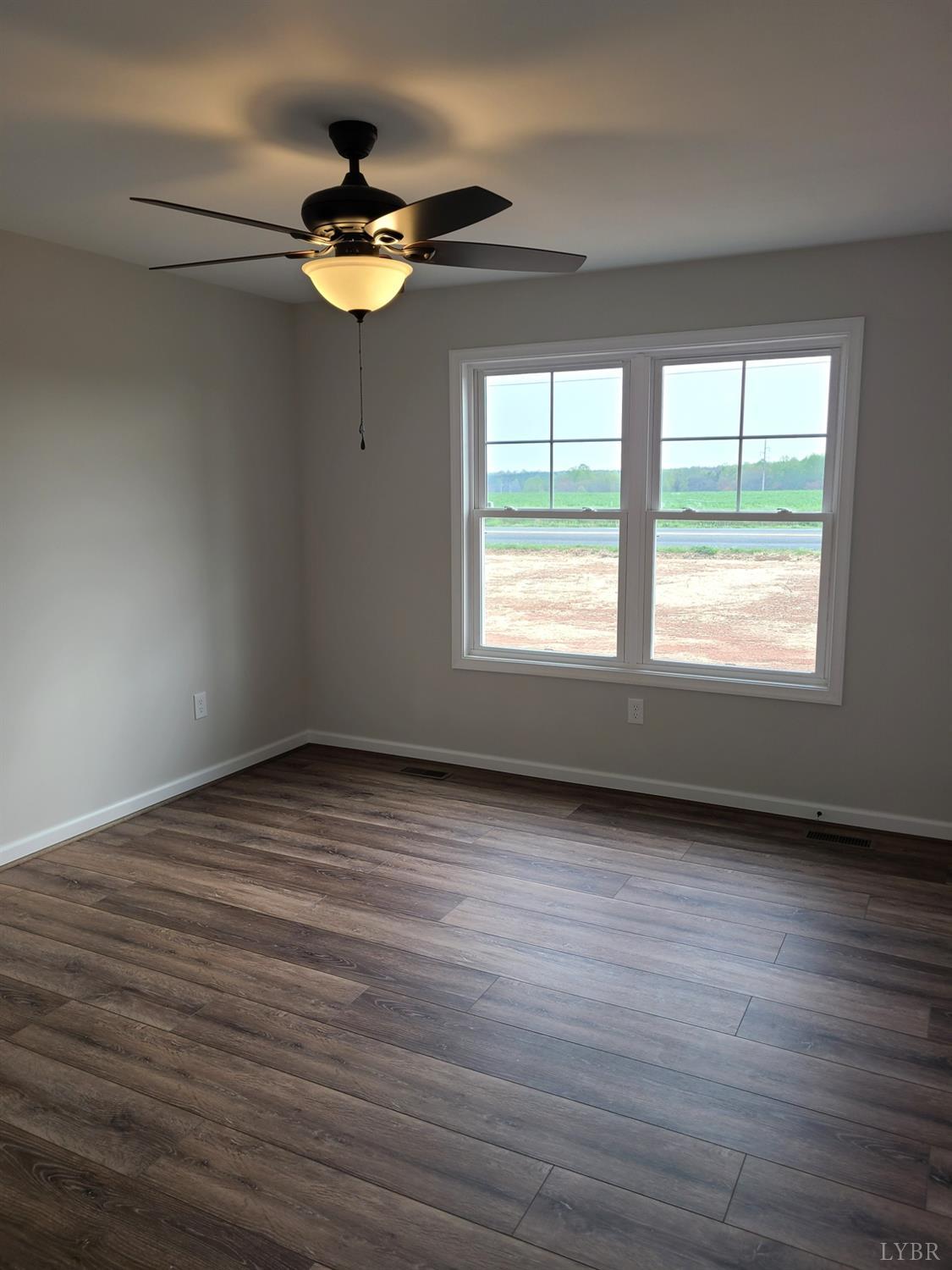 3353 Stonewall Road Concord, VA 24538 - Photo 11 of 21 a view of empty room with wooden floor and fan