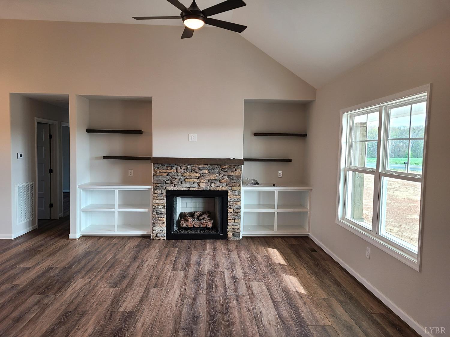 3353 Stonewall Road Concord, VA 24538 - Photo 5 of 21 a living room with a fireplace and wooden floor