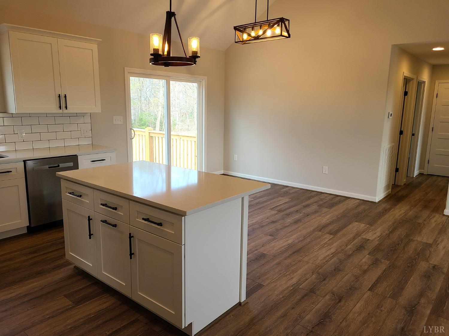 3353 Stonewall Road Concord, VA 24538 - Photo 7 of 21 a kitchen with granite countertop a stove a sink a refrigerator and wooden floor