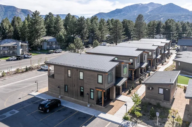a view of multiple houses with a road