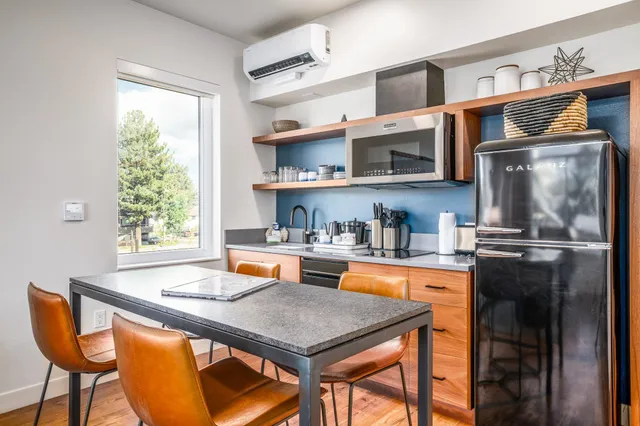 a kitchen with stainless steel appliances granite countertop a stove a sink and a refrigerator