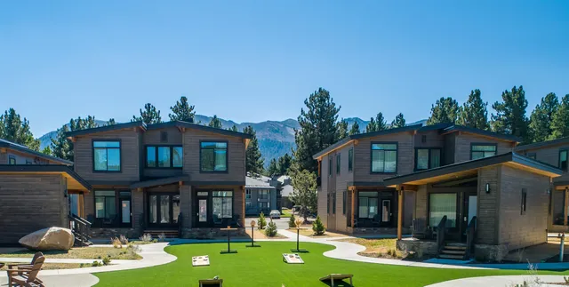 a view of a patio with couches table and chairs and potted plants