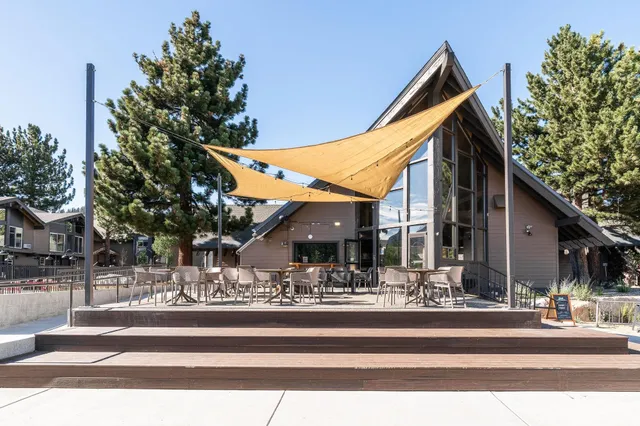 a living room with fireplace furniture and a large window