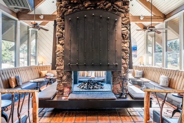 a view of a patio with dining table and chairs under an umbrella